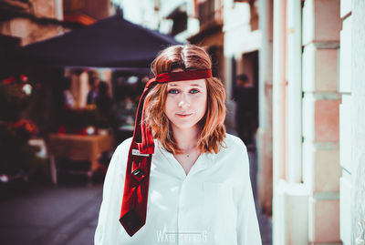 Portrait of young woman standing outdoors