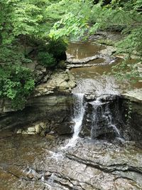 High angle view of waterfall amidst rocks