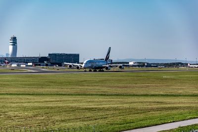 View of airplane on airport runway against sky