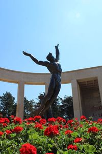 Low angle view of statue against blue sky