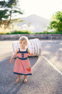 Full length of cute girl walking on road