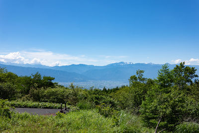 Scenic view of mountains against blue sky