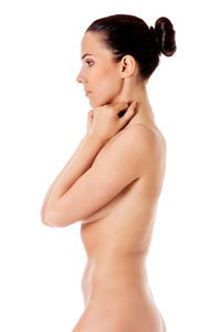 Side view of a young woman against white background