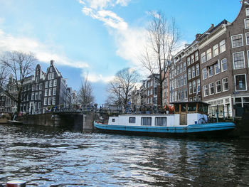 Boats on canal in amsterdam