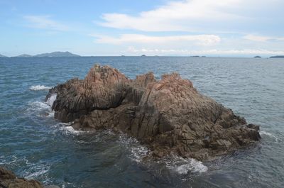 Rock formations in sea against sky