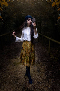 Full length of young woman standing in park