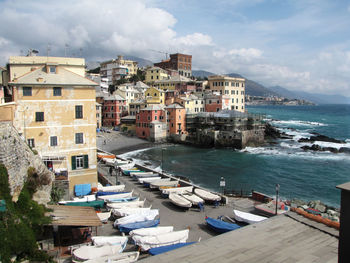 View of town by sea against sky