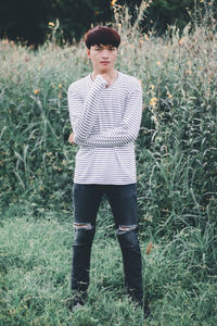 Portrait of teenage girl standing on field