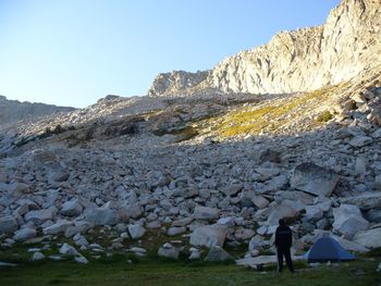 Rear view of man standing by mountain at yosemite valley