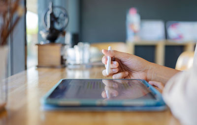 Midsection of woman using mobile phone