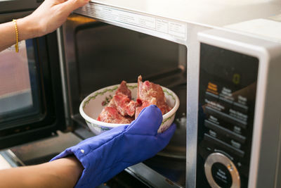 Midsection of person preparing food in kitchen