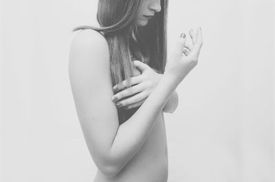 Close-up of woman standing against white background