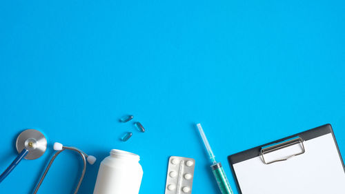 Low angle view of electric lamp against blue sky