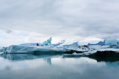 Scenic view of lake against sky during winter