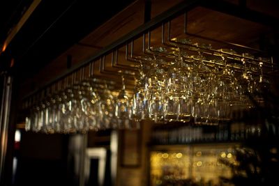 Close-up of suspended wine glasses in restaurant