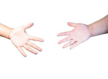 Close-up of hands over white background