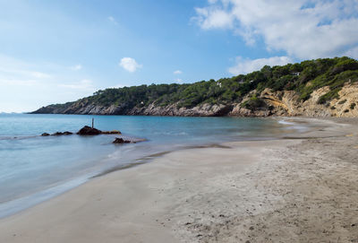 View of beach against cloudy sky