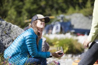 Attractive young woman enjoys glass of wine during luxury tour.