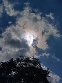 Low angle view of rainbow over trees against sky