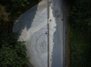 High angle view of man with bicycle on road