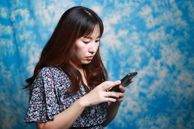 Young woman using mobile phone