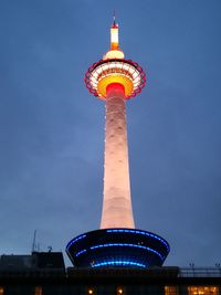 Low angle view of illuminated building against blue sky