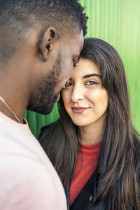 Portrait of young couple kissing outdoors