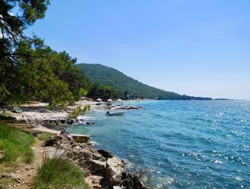 Scenic view of sea against clear blue sky