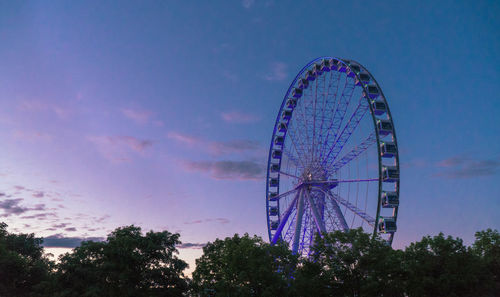 Low angle view of ferris wheel against sky