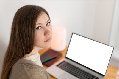 Pretty girl tired of working at computer. working from home office. woman looking into camera.