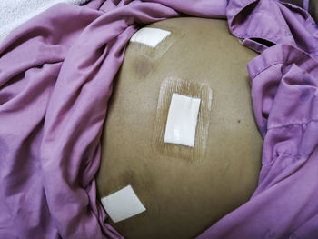 High angle view of man relaxing on bed