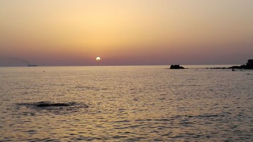 Scenic view of sea against clear sky during sunset