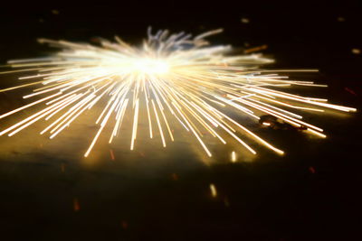 Low angle view of firework display at night