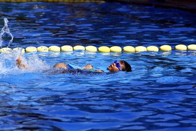 Boy with kickboard in swimming pool