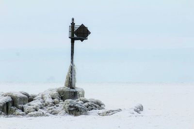 Scenic view of frozen lake erie against sky during winter