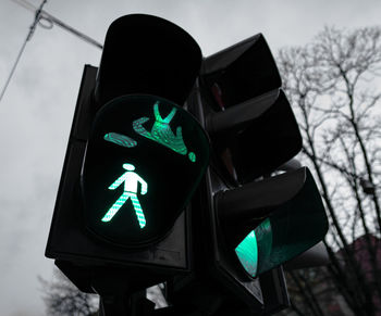 Low angle view of green light on traffic light in city.