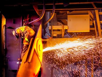 Rear view of man working at factory
