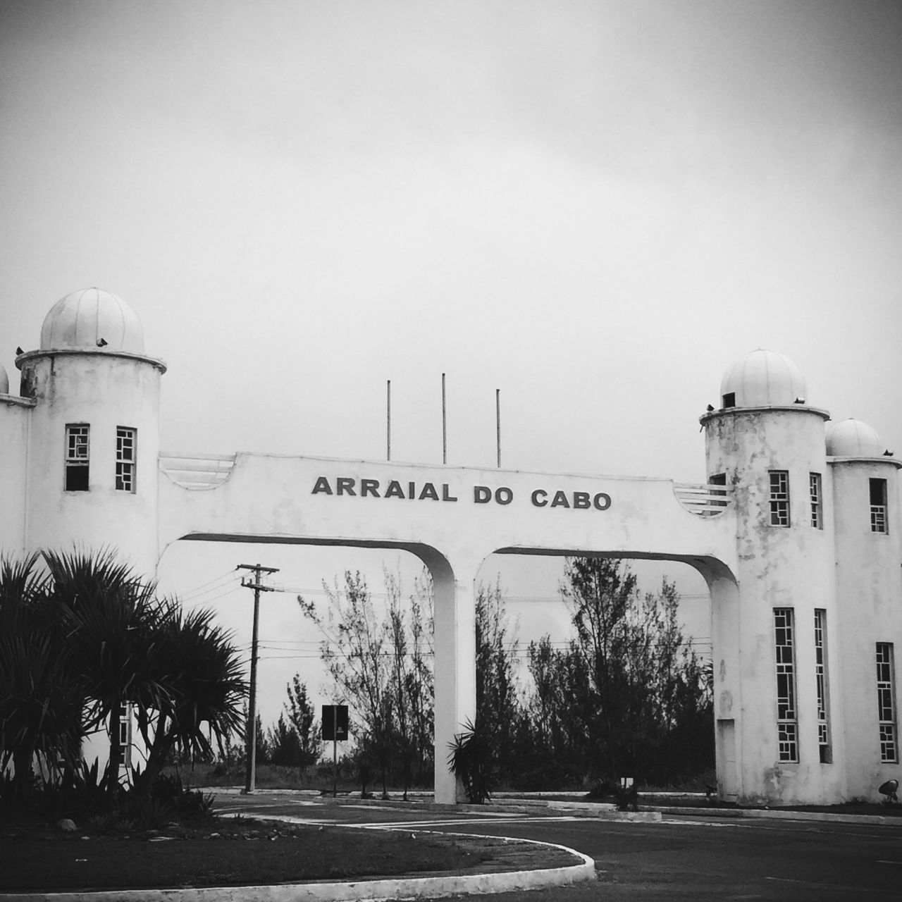 text, architecture, built structure, western script, building exterior, communication, clear sky, information sign, information, sign, road, tree, street, guidance, non-western script, outdoors, no people, day, road sign, capital letter