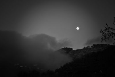 Scenic view of mountains against sky at night