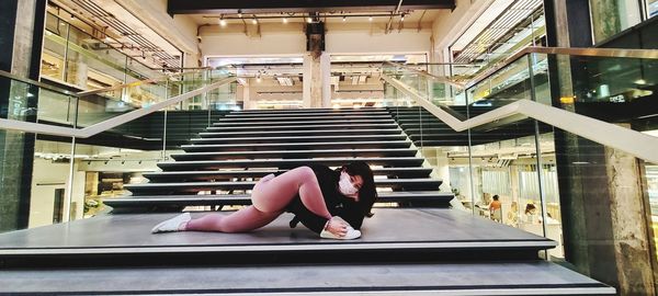 Woman sitting on staircase