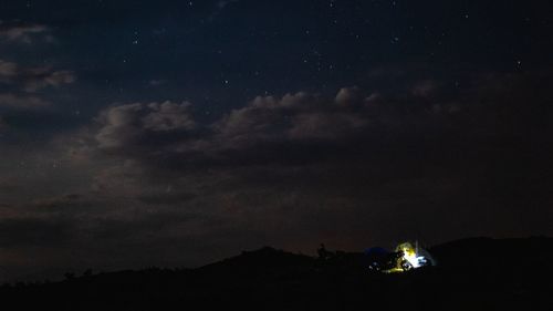 Scenic view of silhouette mountain against sky at night