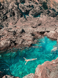 High angle view of woman swimming in sea