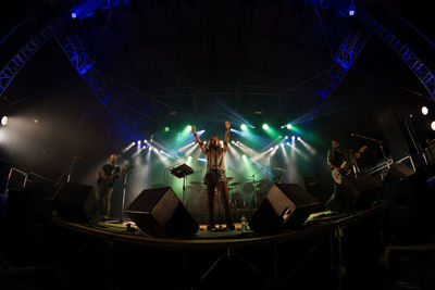 People enjoying illuminated music concert at night