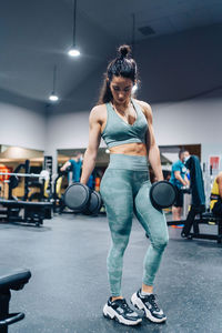 Side view of woman exercising in gym