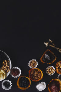 High angle view of cupcakes on table against black background