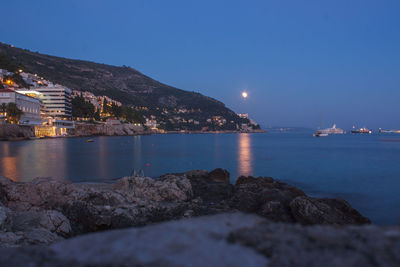 Scenic view of sea against clear sky at night