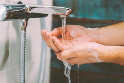 Midsection of woman in bathroom at home