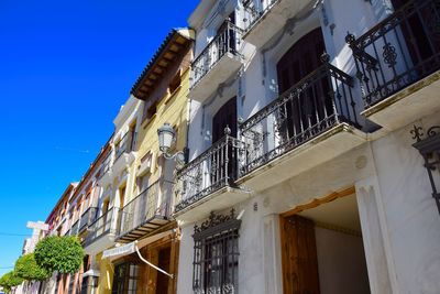 Low angle view of buildings against blue sky