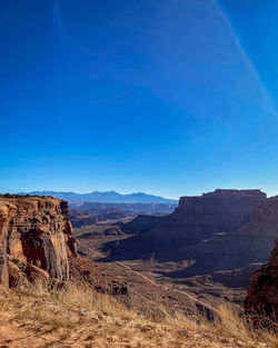 Scenic view of mountain against blue sky