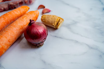 Selective focus of carrots on a white marble background